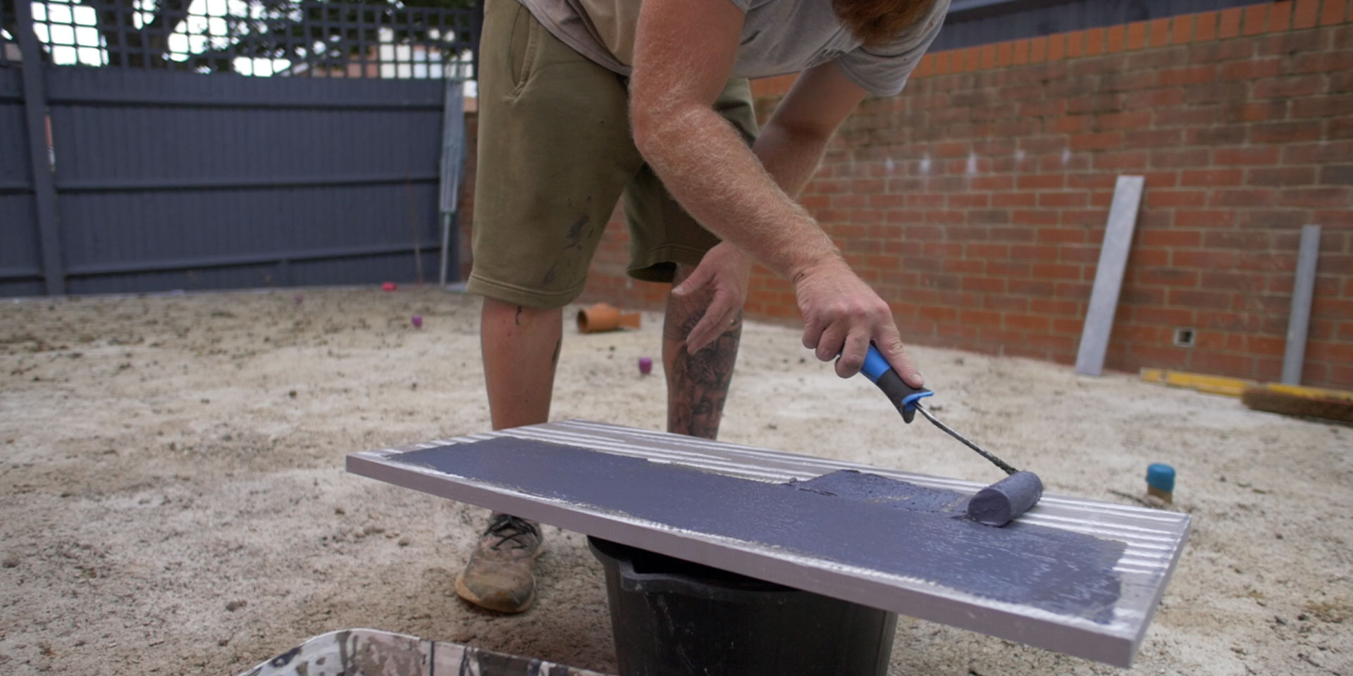 Primer being added to the back of a porcelain tile in Southampton, Hampshire.