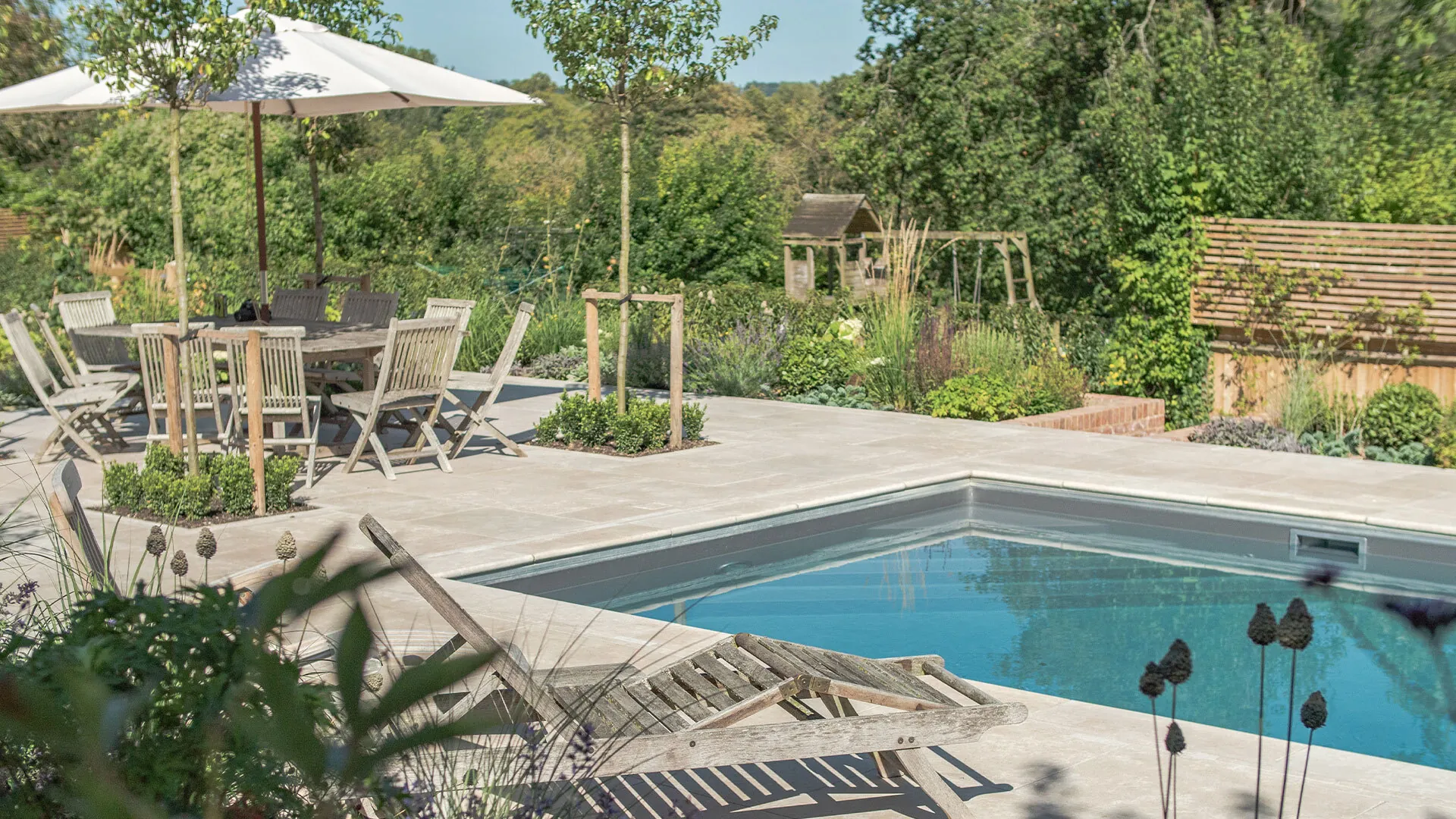 Lymington Beige limestone copings and paving around a swimming pool in Winchester